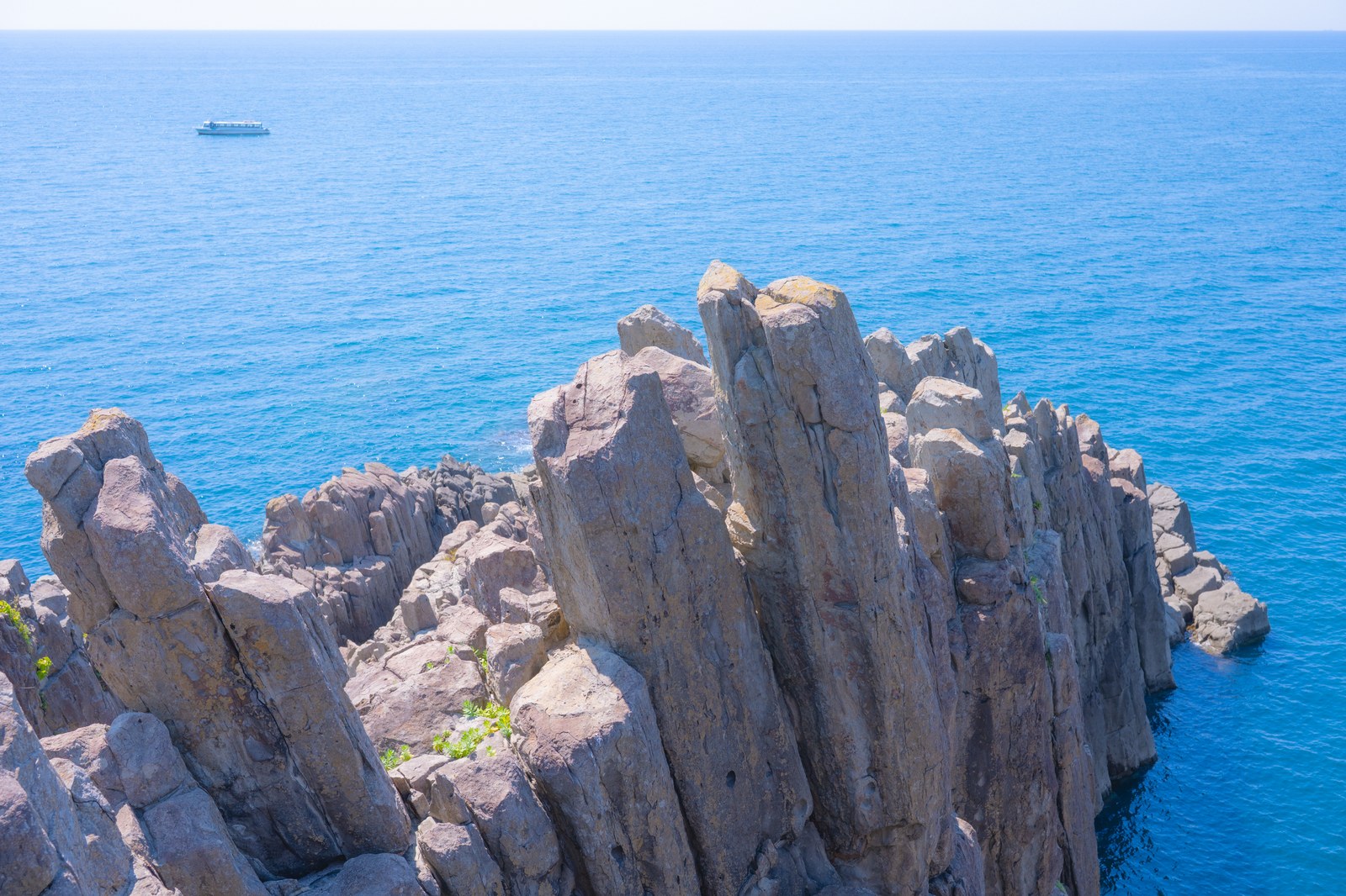 Tojinbo at dusk, with columnar cliffs falling sheer into the Sea of Japan and waves below
